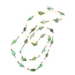 An early 20th C necklace of white chalcedony and green turquoise stones, linked by a white metal