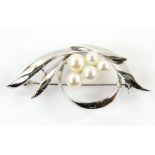 Mikimoto brooch, with five white round pearls, mounted in rhodium plated silver, pin and roll