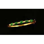 Vintage jade and diamond bangle, set with five oval cut jade cabochons alternately set with four