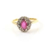 Vintage ruby and diamond set dress ring with oval cut stone 6.6 x 5.6 x 2.3 mm within a border of