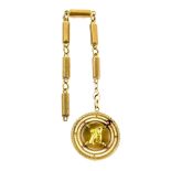 Vintage gold pendant, central disk depicting a women pouring water out of a jug, in 18 ct bearing