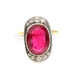 An Art Deco period ring set with large synthetic ruby and white sapphire, bearing French mark for 18