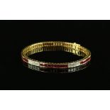 Ruby and diamond line bracelet, set with twenty four princess cut diamonds, estimated total