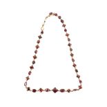 Late Georgian riviere necklace, with oval, round and diamond shaped cut foil backed garnets,