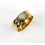Vintage ring, centrally set with oval cabochon cut opal, 7 x 5mm, rub-over set on faceted band, ring
