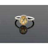 Citrine and diamond dress ring, oval cut citirne, with round brilliant cut diamond border and