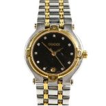 Gucci a ladies bi metal wrist watch, the signed black dial with faux diamond hour markers, fitted
