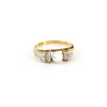 Continental 1940's style ring set with a single pearl, the scroll shoulders with small diamonds,