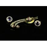 A pair of earrings set with synthetic colour change sapphire and white sapphire, post and clip