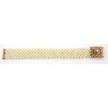 Pearl bracelet, of seven interconnecting rows to an unmarked gold clasp, 17 cm, length, boxed .