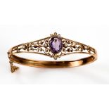 Edwardian hinged bangle, central oval cut amethyst, seed pearls set shoulders in fine wire mounts,