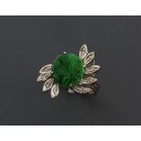 Jade and diamond ring, round floral carved jade panel, surrounded by nine marquise petals set with