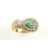 1970's Abstract emerald ring, central pear cut emerald, estimated weight 0.37 carats, surrounded