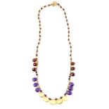 An amethyst garnet and citrine fringe necklace with faceted pear form drops to a filigree 9 ct