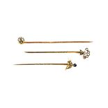 Three stick pins, one set with an old cut diamond, estimated diamond weight 0.45 carat, with