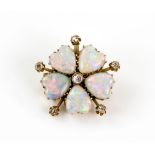 Edwardian floral brooch pendant, set with five cabochon cut opal petals, and six old cut diamonds,