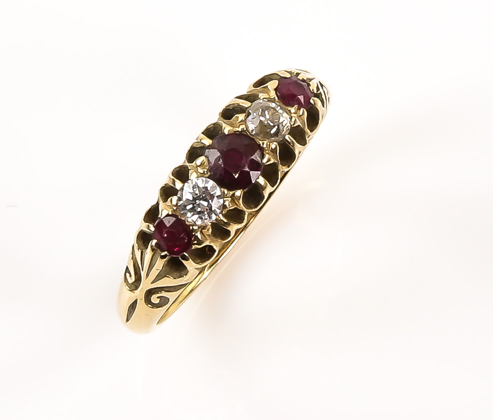 Early 20th C ruby and diamond ring, set with three round cut rubies, a old cut diamond and white