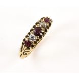 Early 20th C ruby and diamond ring, set with three round cut rubies, a old cut diamond and white