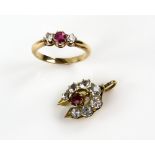 Ruby and diamond three stone ring, with central step cut ruby within a border of brilliant cut