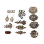 A group of brooches, including eight silver Victorian brooches and a pair similar of drop earrings .