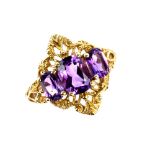 Amethyst three stone dress ring, ornate mount, testing as 9 ct, ring size N. CONDITION 9 ct gross