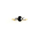 Vintage sapphire and diamond dress ring, centrally set oval cut sapphire, with two round brilliant