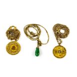 Three Chinese pendants, including two disk shaped pendants with character details, both with chains,
