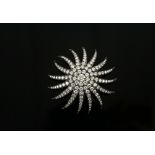 Art Deco period diamond sun brooch, set with transitional cut diamonds, central diamond estimated at