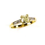 Fancy coloured diamond ring, central yellow cushion cut diamond, shoulders set with eight round