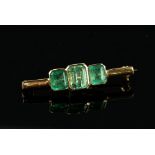 Three stone emerald bar brooch, all rectangular step cut, estimated total weight 3.69 carats,