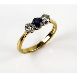 Three stone sapphire and diamond ring, with central round sapphire and two brilliant cut diamonds,