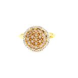Contemporary diamond cluster ring, nineteen round brilliant cut yellow diamonds, surrounded by a
