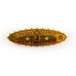 Victorian brooch, set with a central ruby and two old cut diamonds, with wirework and floral