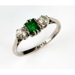 Vintage platinum ring set with two old cut diamonds and a step cut emerald, diamond weight estimated