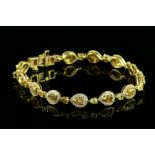 Fancy coloured diamond bracelet, with pear cut yellow diamonds of varying hues, estimated total