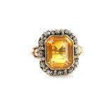 Dress ring, central step cut citrine, set within a border of rose cut diamonds, bearing Portuguese