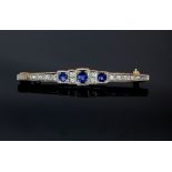 Art Deco period brooch, central oval cut sapphire 4.7 x 3.8mm, one round cut sapphire and one