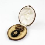 Victorian mourning pendant, central seed pearl star motif, reverse hair locket panel, black enamel