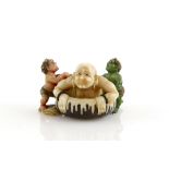 A Yasuaki (Homei) School, coloured netsuke of two Oni assisting a Sennin to bath; signed