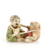 A Yasuaki (Homei) School, coloured netsuke, carved as Daruma neck wrestling with Daikoku, signed