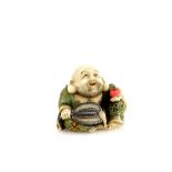 A Yasuaki (Homei) School coloured ivory netsuke of Hotei, seated with a fan and hossu in his right