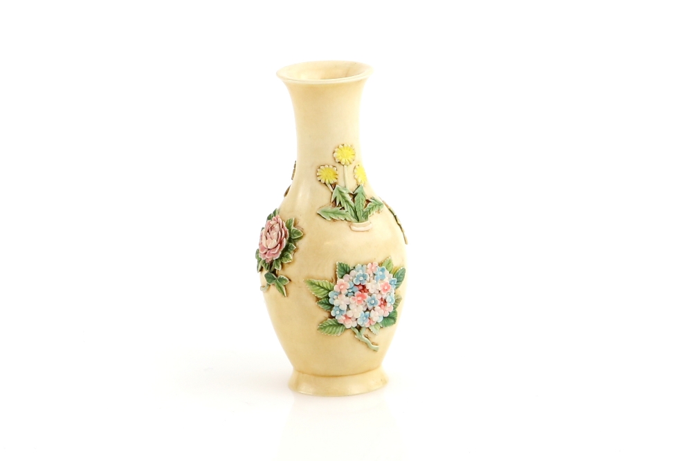 A small Chinese ivory vase, decorated on the exterior with floral designs, 6 cm high, the base