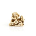 A small ivory okimono of Raijin, The Thunder Deity, with both his sons beside the Thunder Drums, 4cm
