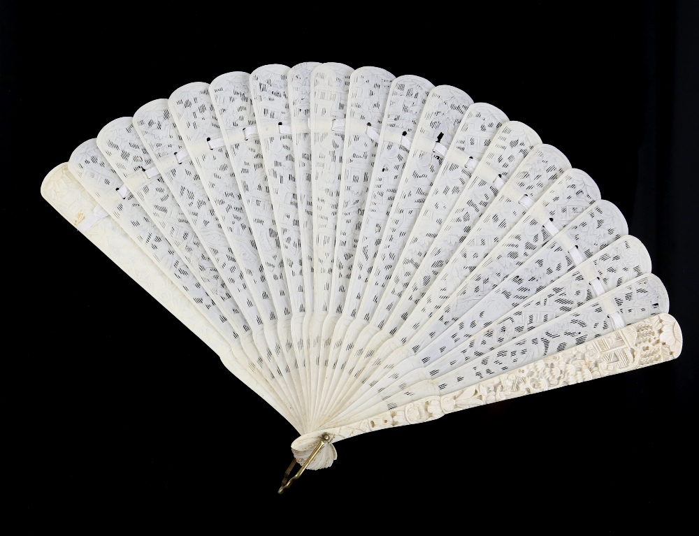 A Cantonese ivory fan with 20 sticks; each stick of typical reticulated form carved with designs - Image 2 of 2