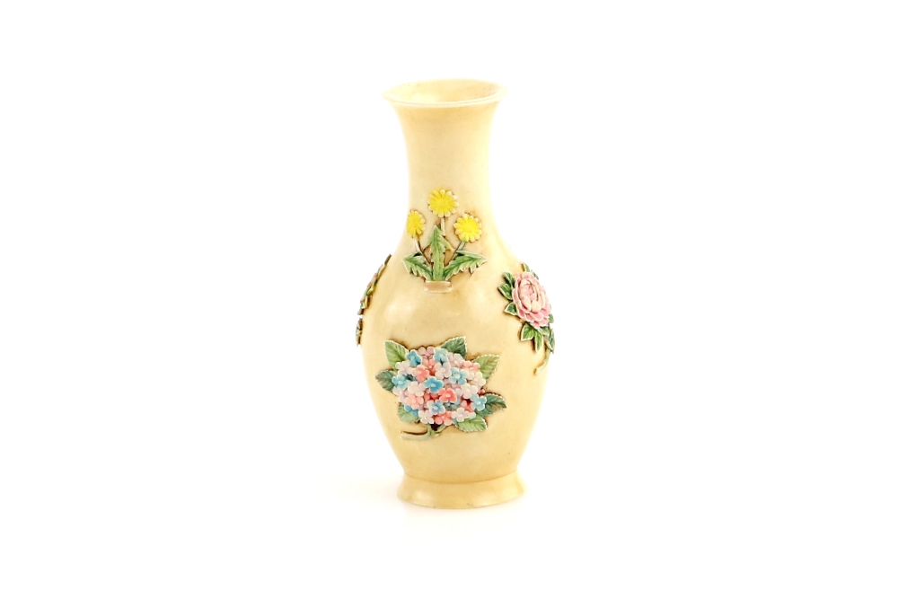 A small Chinese ivory vase, decorated on the exterior with floral designs, 6 cm high, the base - Image 2 of 3