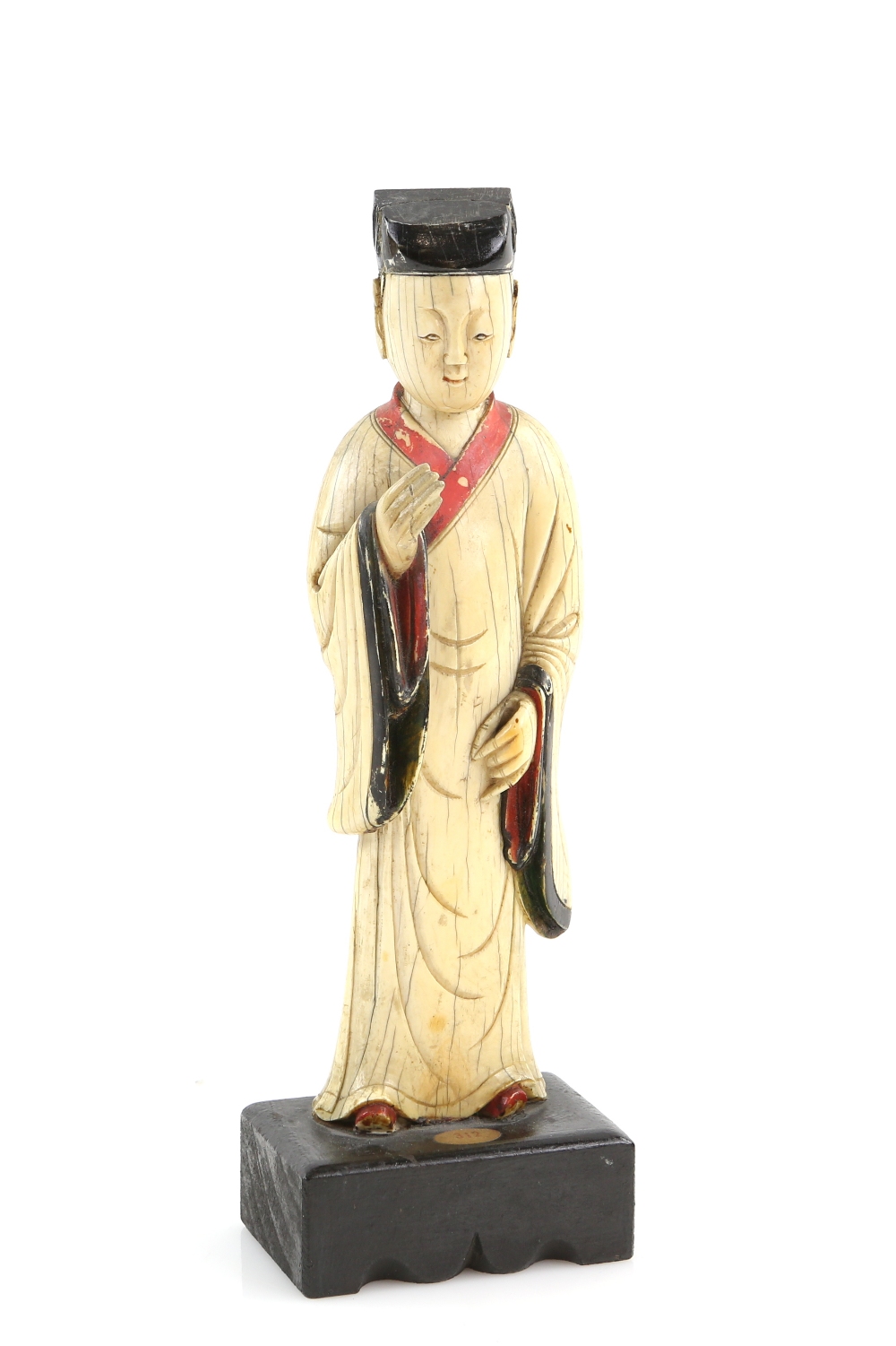 A Chinese ivory carving of a standing scholar, 21 cm high, Qing Dynasty, attached to a rectangular