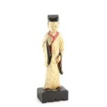 A Chinese ivory carving of a standing scholar, 21 cm high, Qing Dynasty, attached to a rectangular