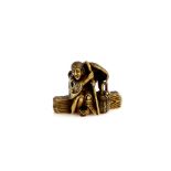 A stained ivory netsuke of the Heian waka poetess, Ono no Komachi (circa 825-900), seated on a log