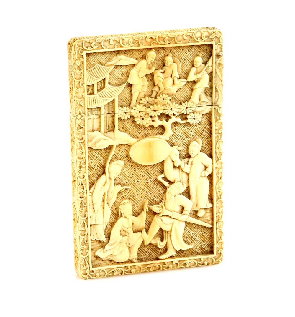 An elegant Canton ivory card case, carved on both front and back with Manchu or Chinese figures in