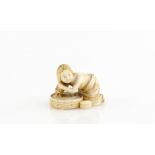 An ivory netsuke of a girl, washing her hair, signed NagamitsuProvenance: The Property of a Lady.